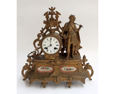 A French Henry Marc gilt metal figural mantle clock, the circular Roman numeral dial flanked by a standing figure, 35cmH