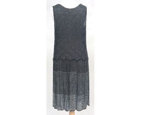 Beaded muslin flapper dress, with scalloped dropped waist and scalloped hem, the dark blue ground worked with clear and pearl