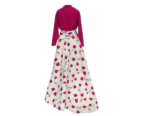 A flamboyant 1950s house coat, tight-fitting shocking pink wool jersey bodice with raglan sleeves, heavy quilted wide satin s