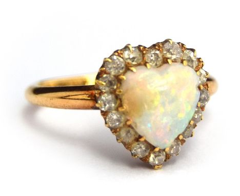 An 18ct gold opal and diamond heart-shape ring, the central heart-shape opal cabochon surrounded by old cut diamonds in gold 