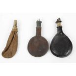 Three leather shot flasks: two circular with Irish brass dispensers, one bag shaped with patent