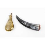 A brass powder flask with embossed decoration and a horn powder flask with brass mounted