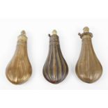 Three copper and brass powder flasks with similar embossed fluted decoration, two stamped G & J W