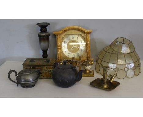 A selection of miscellaneous items, gilt bookends, lamp shade, candlestick, cast teapot, biscuit tin, clock plated wares, bra