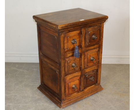 A modern imported wood six drawer chest, with fielded short drawers with ring handles and double panelled sides 82cm x 55cm x