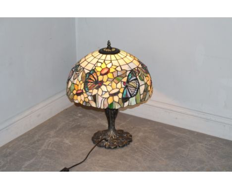 A modern electrical table lamp, in the style of Tiffany, the leaded style and coloured glass shade decorated with flowers and