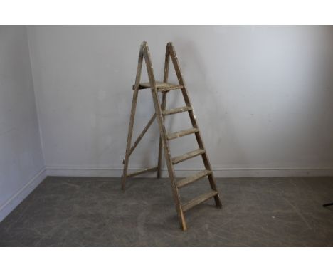 A set of pine step-ladders, of traditional form 148cm some old worm damage
