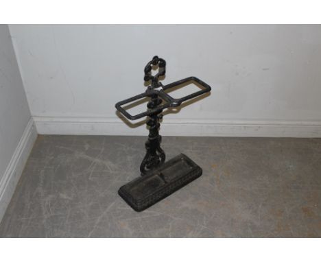 A cast-iron two division stick/umbrella stand, with foliate and reed moulded central supporting column, and bead-moulded divi