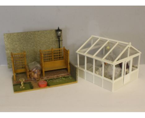 A doll's house garden setting and green house, with a variety of associated items, furniture, garden pots etc, wired for ligh