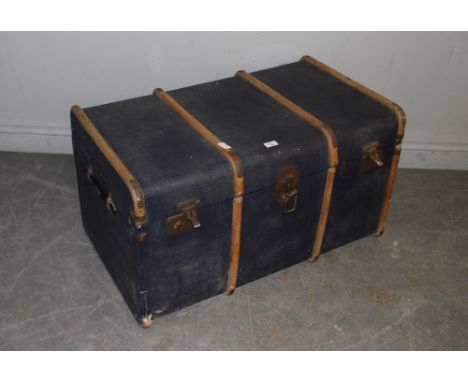 A large ribbed blue canvas travel trunk 51cm x 91cm x 53cm one end rib missing.