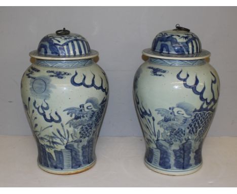 A pair of Chinese blue and white lidded urns, the domed covers with metal ring handles over baluster bodies decorated with ky