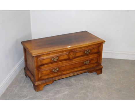 A reproduction oak television/media cupboard, in the manner of Titchmarsh and Goodwin, the hinged fall-front formed as three 