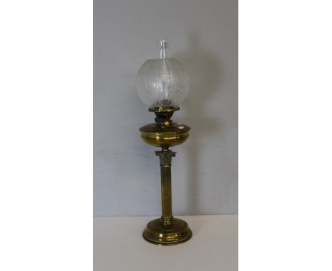 An early 20th century brass Corinthian column oil lamp, with etched globular glass shade over the Duplex burner with twin adj