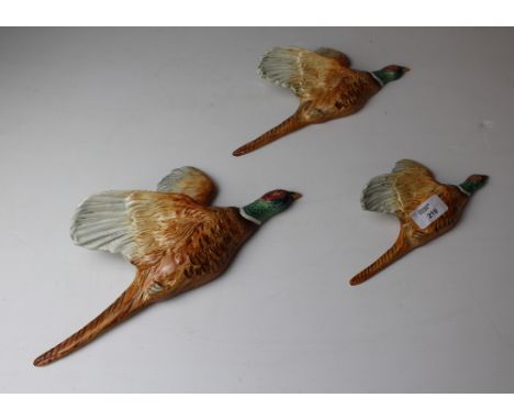 A graduating set of three Beswick pottery 'flying' pheasant wall plaques, models 661/1, 661/2 and 661/3, the smallest with da