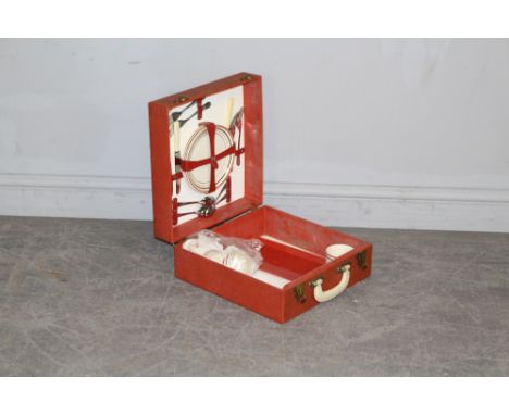 A mid-century red canvas cased 'Sirram' picnic hamper, with four cups, plates, tray and cutlery 15cm x 33.5cm x 34cm