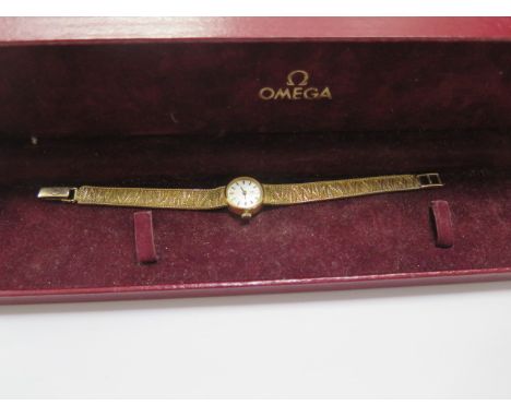 A hallmarked 9ct yellow gold manual ladies Omega bracelet wristwatch, approx 18 grams, running, with box , there is a split t