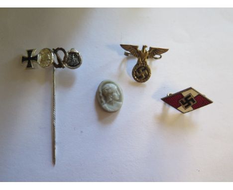 A WWII Hitler Youth enamel pin, a medal group pin, an Eagle badge and a small cameo 