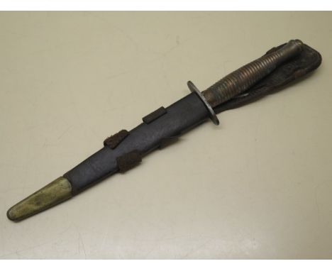 A Commando dagger with scabbard, blade length 17cm, some pitting but generally good 