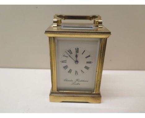 A brass carriage clock, the dial signed Charles Frodsham, London, 13cm tall with handle down, no key but runs, glass good 