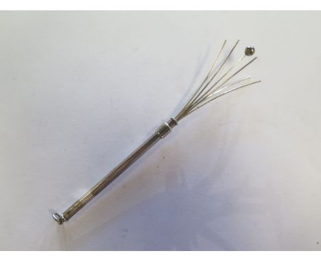 A silver folding twizel stick, 8cm closed 