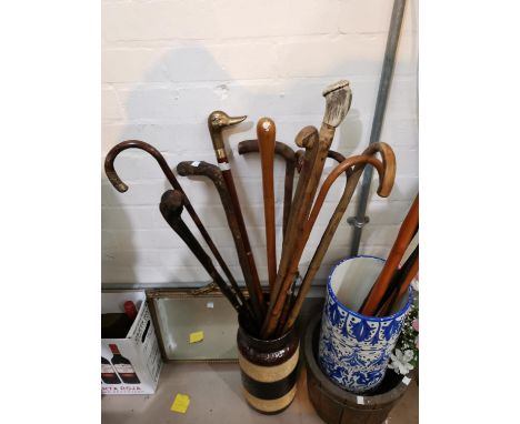 A silver tipped walking stick and a collection of other sticks etc