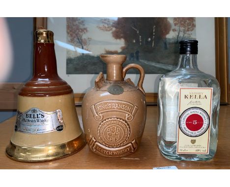 A 75 cl bottle of Kings Ransom Scotch whisky in stoneware decanter; a 75cl bottle of Bells in Wade pottery decanter; a 70cl b