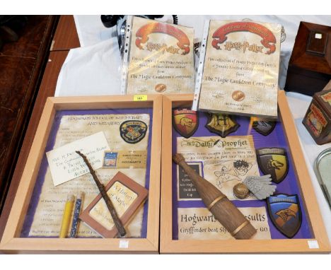 Two 'The Magic Cauldron Company' Limited Edition wall hanging Harry Potter display cabinets containing reproduction 'Wizardin