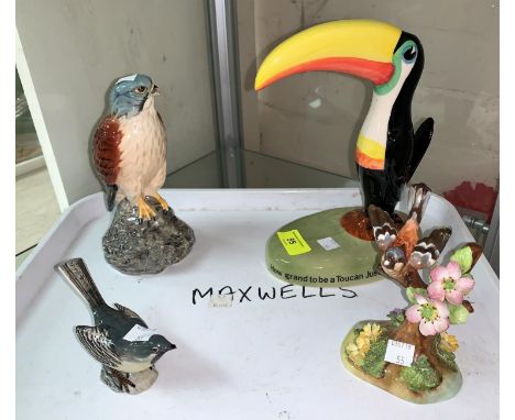 A Carltonware Guiness advertising Toucan, a Beswick Beneagles Kestrel, a Beswick wagtail (beak chipped), a Crown Staffordshir