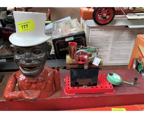 A Mamod stationary steam powered engine and a cast iron money box, man in top hat 