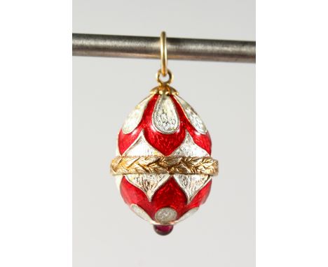 A SMALL RUSSIAN SILVER, RED AND WHITE ENAMEL EGG SHAPED PENDANT. 0.75ins long.