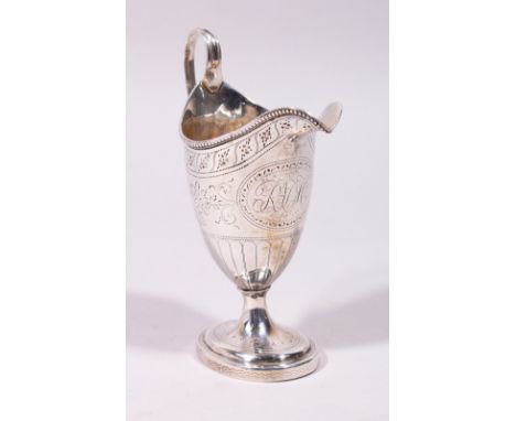 A GOOD GEORGE III ENGRAVED HELMET SHAPED MILK JUG, with reeded handle and base. London 1782.  Maker: Peter &amp; Ann Bateman.