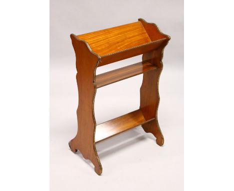 A LATE 19TH CENTURY SATINWOOD BOOK TROUGH, the two book troughs united by a shelf, with shaped sides having ormolu mounts. 1f