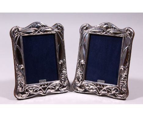 A PAIR OF SILVER AND ENAMEL ART NOUVEAU DESIGN UPRIGHT PHOTOGRAPH FRAMES. 7.5ins x 5.5ins.