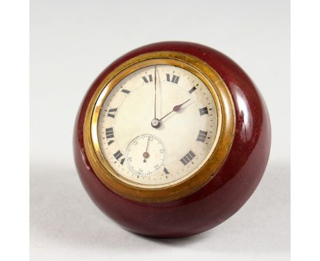 A SMALL CIRCULAR TRAVELLING BEDSIDE CLOCK, with silvered dial and enamel case. 2.75ins diameter.