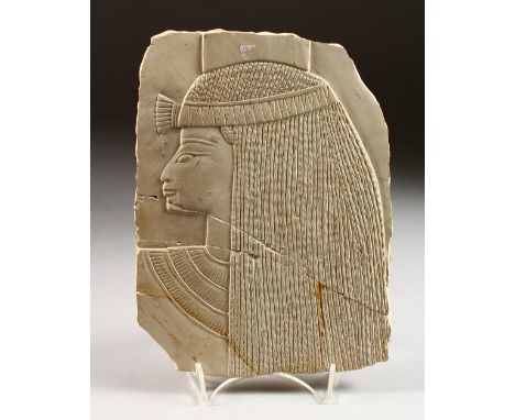 A SMALL LIMESTONE PANEL, carved with a female Egyptian bust. 9ins x 6.5ins.