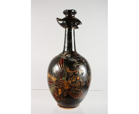 A CHINESE BLACK POTTERY JUG of bulbous shape with calligraphy. 11ins high.