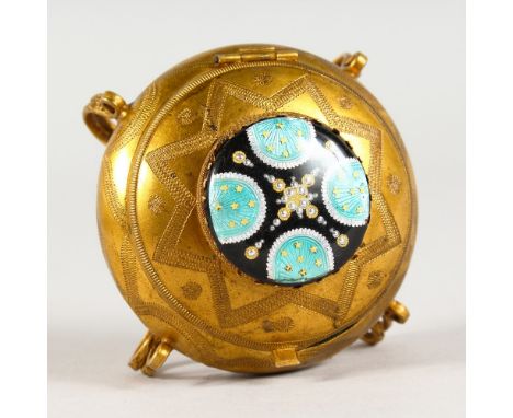 A CIRCULAR GILT METAL BOX, with enamel lid.