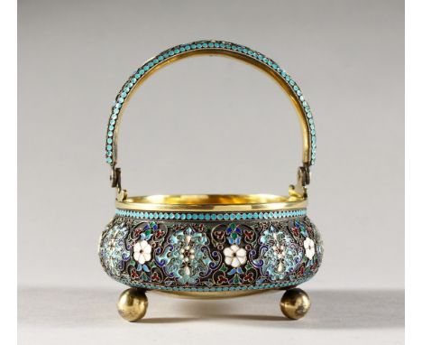 A GOOD RUSSIAN SILVER GILT AND POLYCHROME CLOISONNE ENAMEL CIRCULAR BASKET, with swing handle, on three ball feet. 3.5ins dia