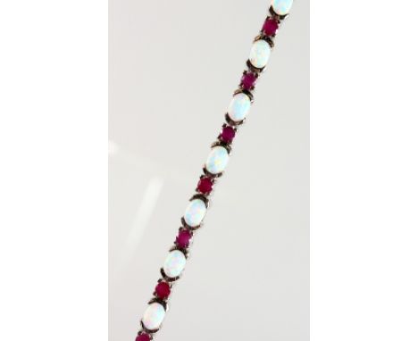 A SILVER, OPAL AND RUBY SET LINE BRACELET.