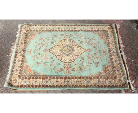 A 20TH CENTURY INDIAN CARPET, green ground with floral decoration. 8ft 10ins x 6ft 0ins.