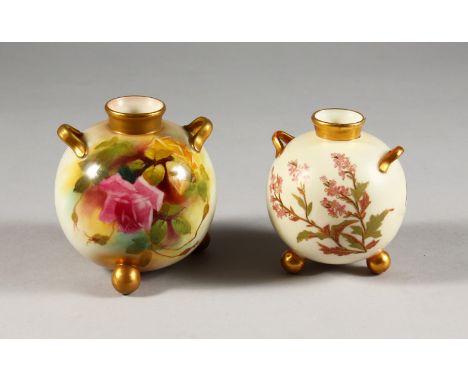 A  ROYAL WORCESTER SPHERICAL TWO HANDLED VASE, on three feet painted with roses C.1912 and a similar smaller ivory ground vas