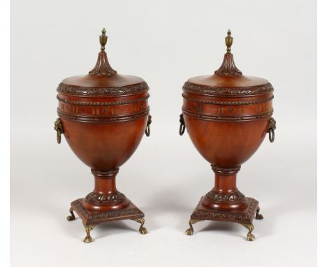 A GOOD PAIR OF ADAM REVIVAL MAHOGANY PEDESTAL URNS OR TEA CADDIES, with well carved decoration, brass finial and lion's mask 