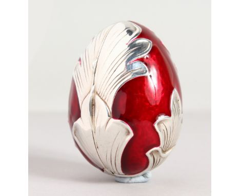A RED ENAMEL AND SILVER EGG.