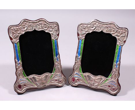 A PAIR OF SILVER AND ENAMEL ART NOUVEAU DESIGN UPRIGHT PHOTOGRAPH FRAMES, repousse with flowers and butterflies. 8ins x 5.5in