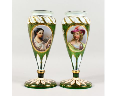 A PAIR OF 19TH CENTURY BOHEMIAN GREEN GLASS VASES, each with an oval panel painted with a portrait bust of a young lady. 11.2