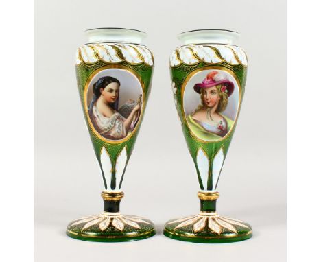 A PAIR OF 19TH CENTURY BOHEMIAN GREEN GLASS VASES, each with an oval panel painted with a portrait bust of a young lady. 11.2