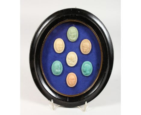 A SET OF SEVEN WAX PORTRAIT BUST SEALS, in an oval glazed frame. 10ins high.