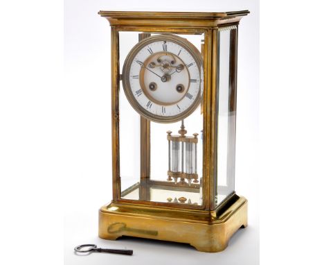 A brass four glass mantel clock, late 19th/early 20th Century, the enamelled roman dial with two train drum movement, strikin