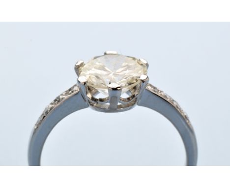 A solitaire diamond ring, the brilliant cut diamond weighing approximately 1.50 carat, six claw set flanked by eight-cut diam