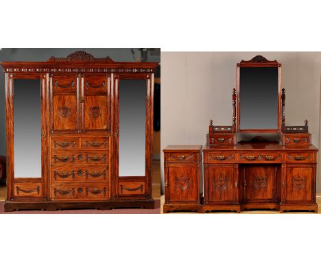 A late Victorian mahogany three piece bedroom suite, to include: wardrobe with blind fret carved pediment above flared cornic